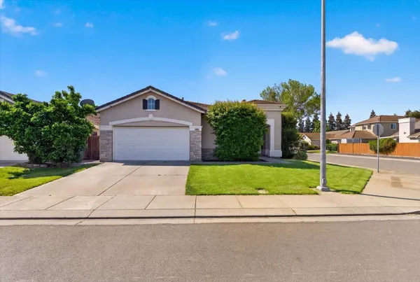 a house with a yard and a garage