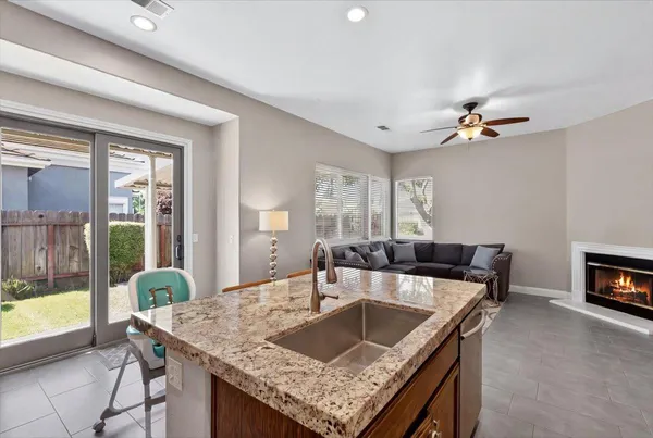 a kitchen with a stove top oven a sink and a refrigerator
