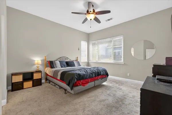 a bedroom with a bed and a dresser