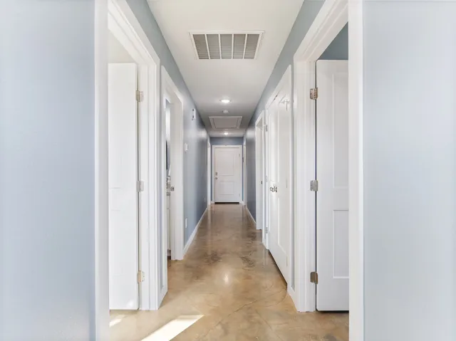 a view of a hallway with washer and dryer