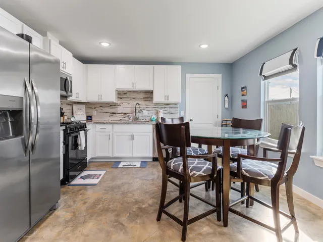 a view of a dining room with furniture and a window