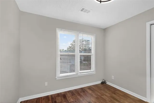 a view of a room with wooden floor and windows