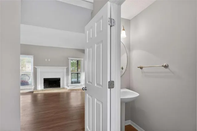a view of a livingroom with wooden floor fireplace and staircase