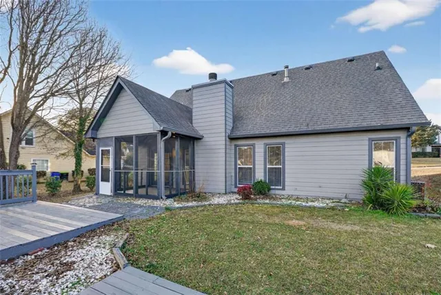 a front view of a house with a yard and potted plants