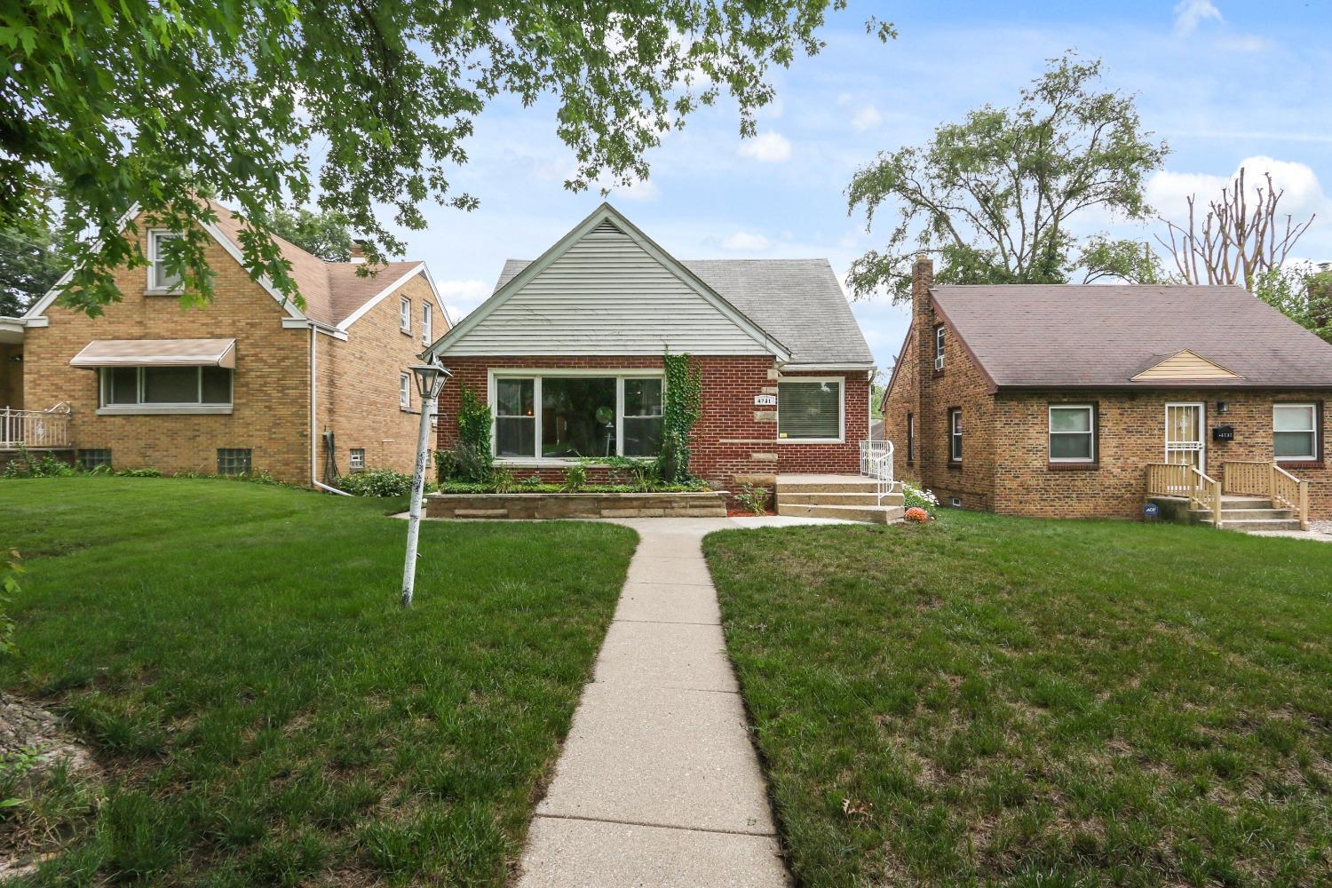 4731 Adams Street Gary, IN 46408 - Photo 1 of 1 a front view of a house with garden