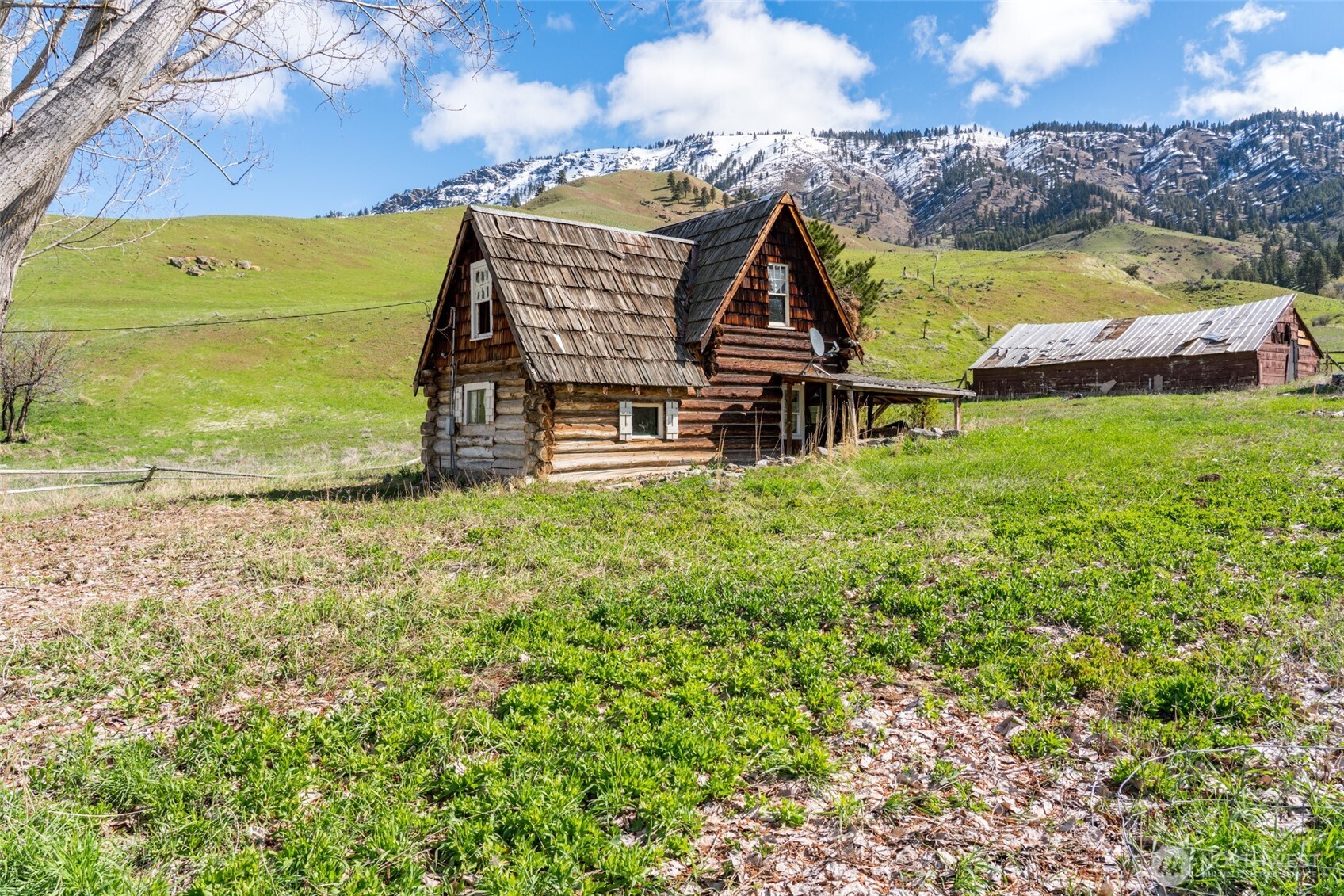 an aerial view of a house with a garden and lake view