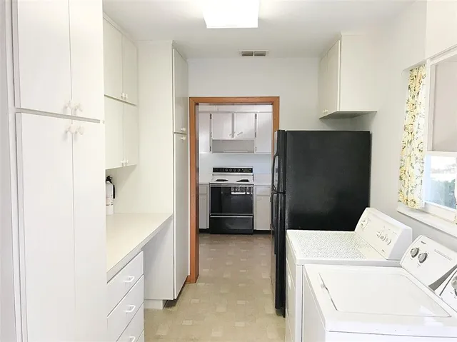 a kitchen with a refrigerator and a sink