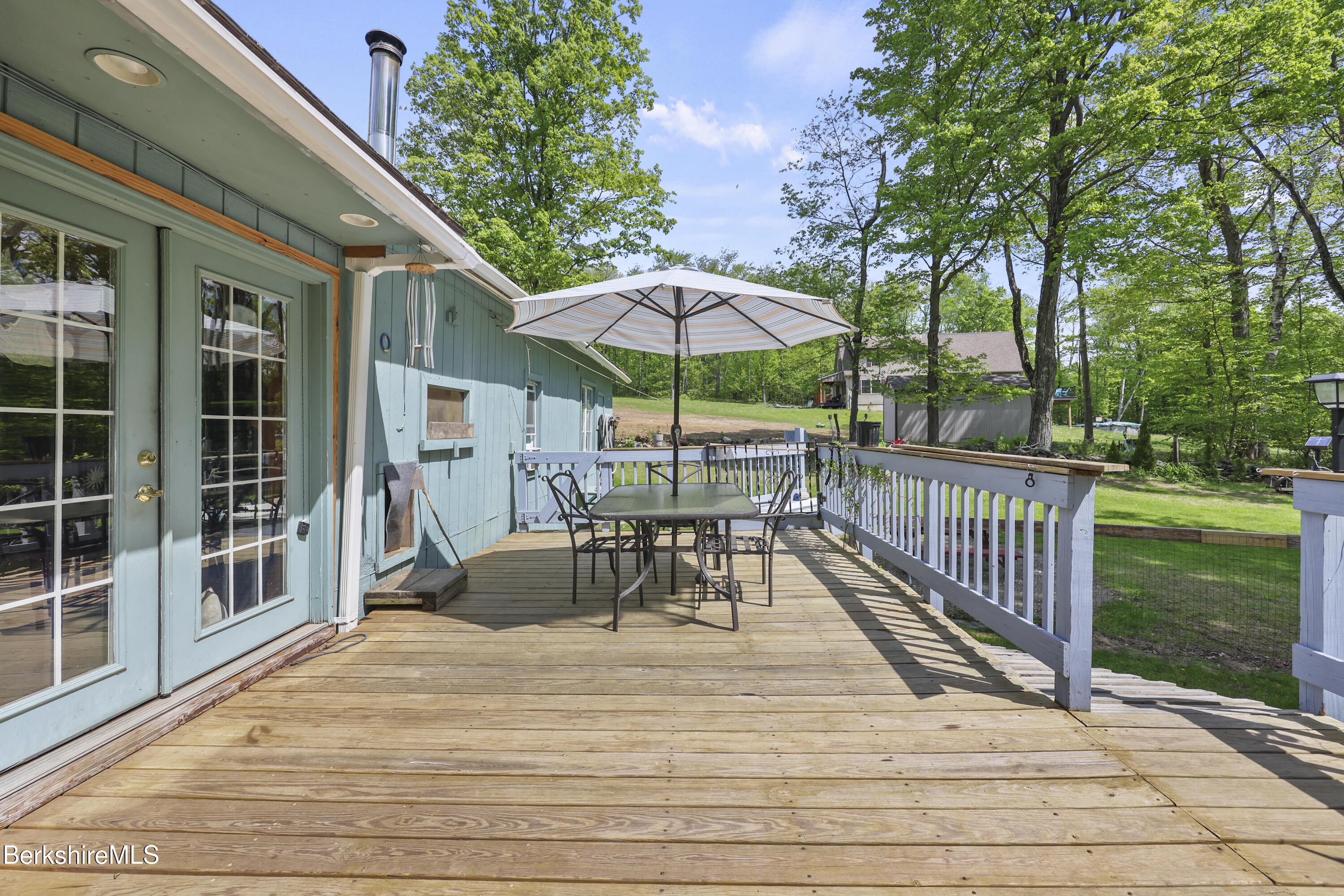 192 Curran Road Cheshire, MA 01225 - Photo 34 of 50 a view of a patio with a table chairs and a backyard