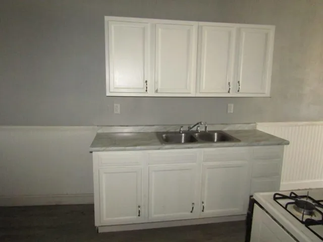 a kitchen with white cabinets