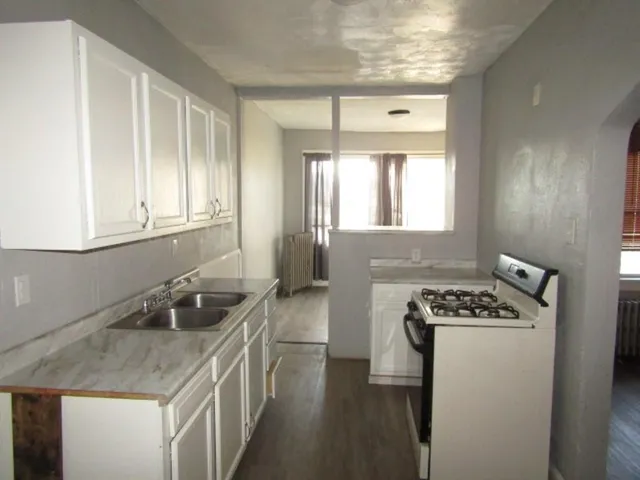 a kitchen that has a sink and a stove