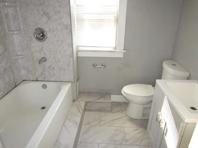 a bathroom with a bathtub and a toilet