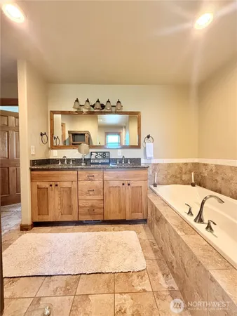 a large kitchen with a stove and white cabinets