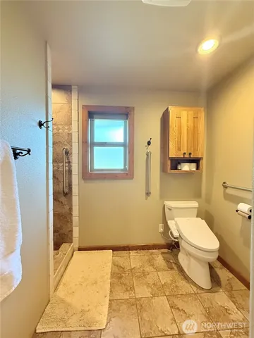 a spacious bathroom with a granite countertop sink and a bathtub