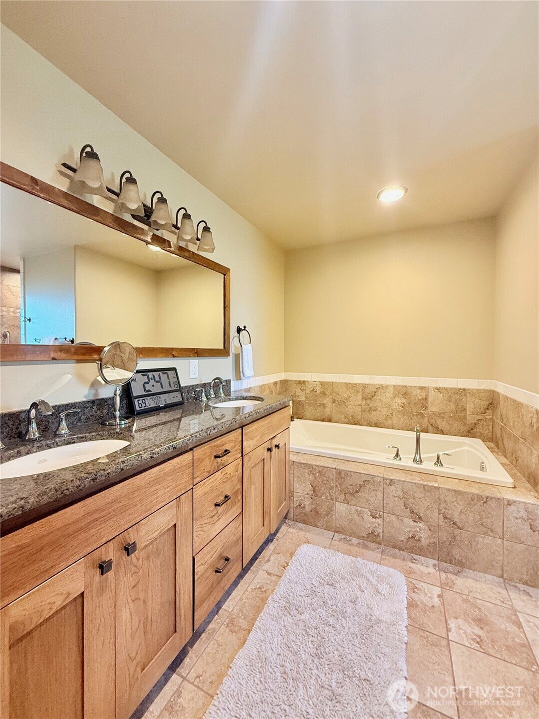 129 Robinson Canyon Road Omak, WA 98841 - Photo 24 of 40 a spacious bathroom with a granite countertop sink and a bathtub