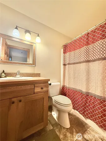 a bathroom with a sink toilet and mirror