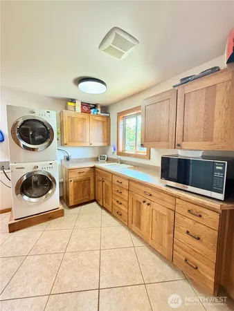 a kitchen with stainless steel appliances a stove a sink a counter space and cabinets