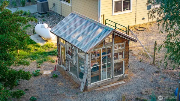 a view of a house with backyard and sitting area