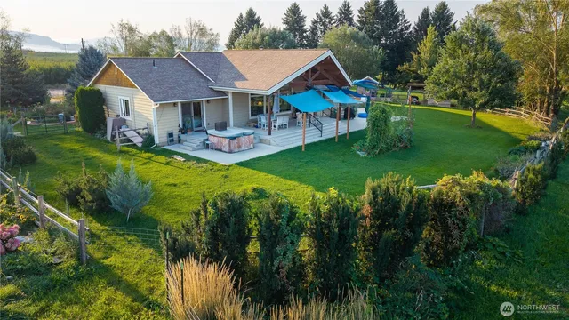 a aerial view of a house with swimming pool and porch with green space