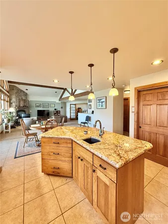 a kitchen with a stove a sink and chandelier