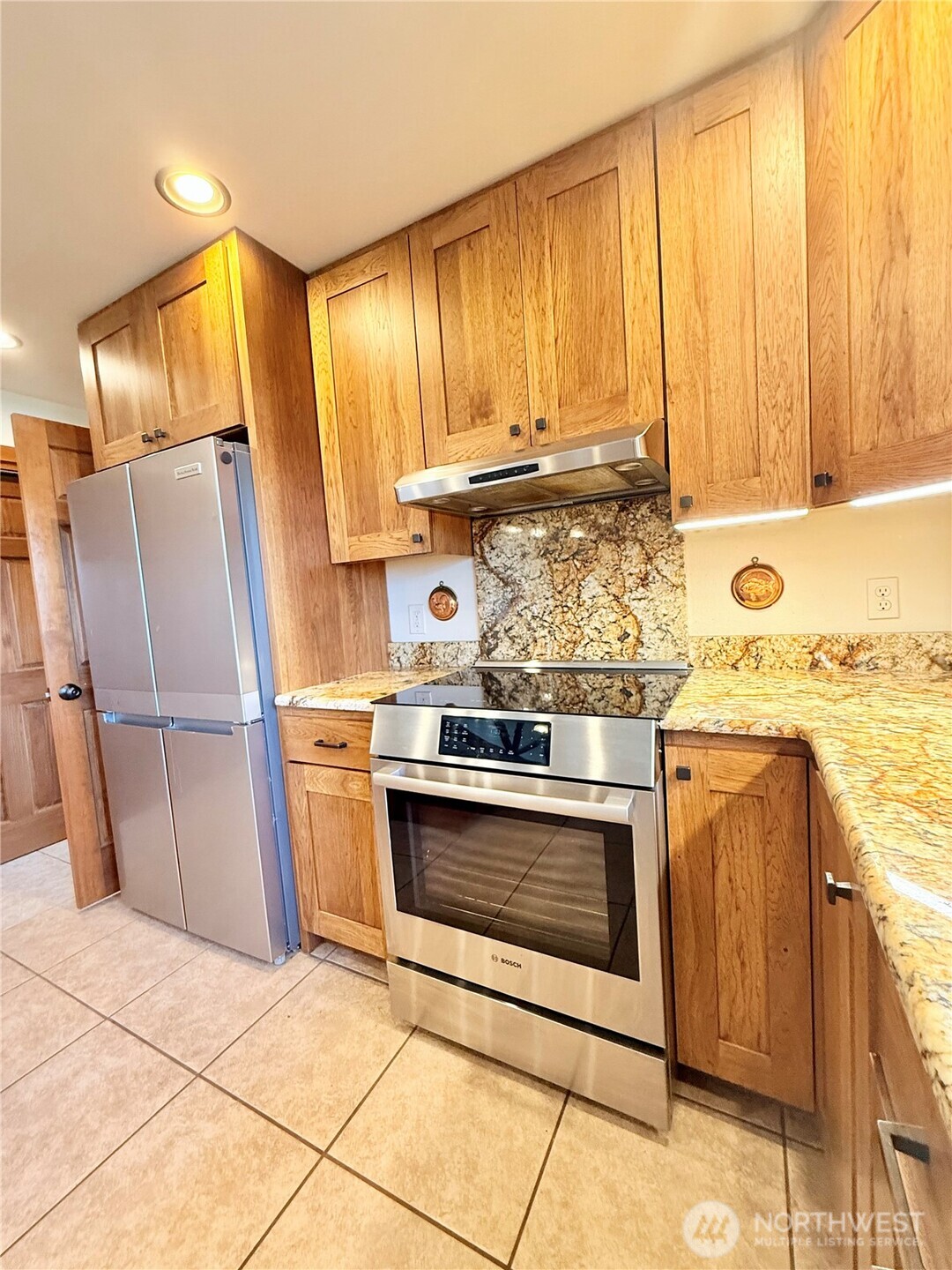 129 Robinson Canyon Road Omak, WA 98841 - Photo 7 of 40 a kitchen with stainless steel appliances granite countertop a stove a sink and a refrigerator