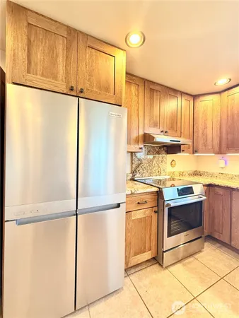 a kitchen with a refrigerator sink stove and cabinets