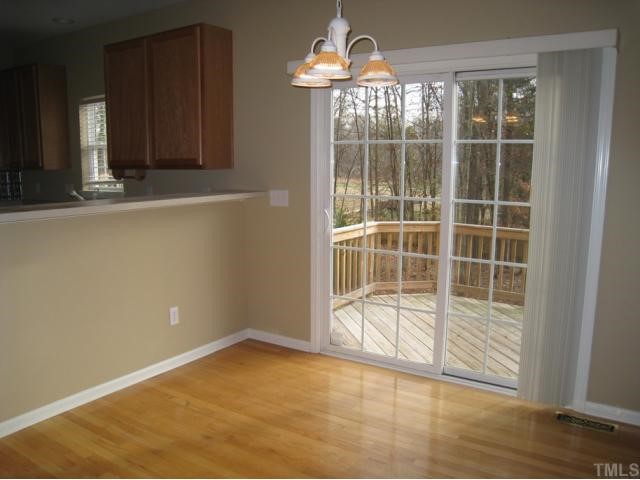 2324 Spruce Shadows Lane Raleigh, NC 27614 - Photo 3 of 12 Breakfast room also offers chandelier, hardwood flooring, and door to deck!