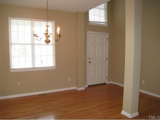 2324 Spruce Shadows Lane Raleigh, NC 27614 - Photo 6 of 12 Dining room offers hardwood flooring, accent wall color, elegant chandelier, columns, open to family room & foyer!