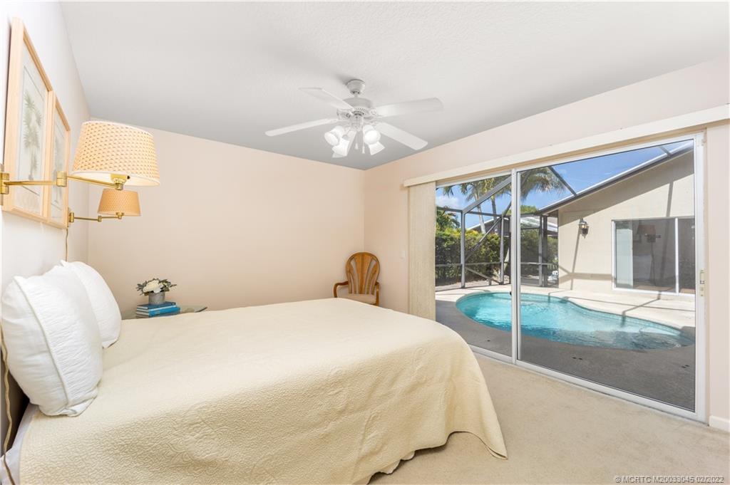 2441 Southwest Omega Way Stuart, FL 34997 - Photo 20 of 37 Guest Bedroom with slider leading to Private Pool