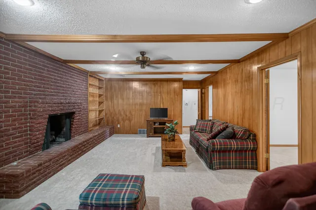an empty room with chandelier fan