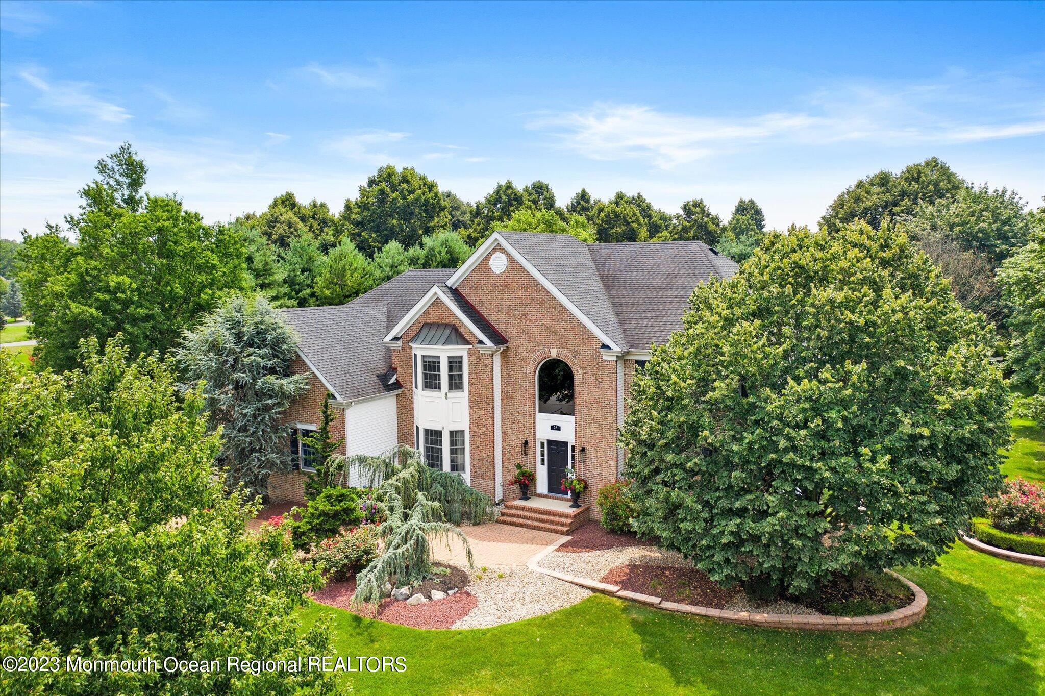 a house with green field in front of it