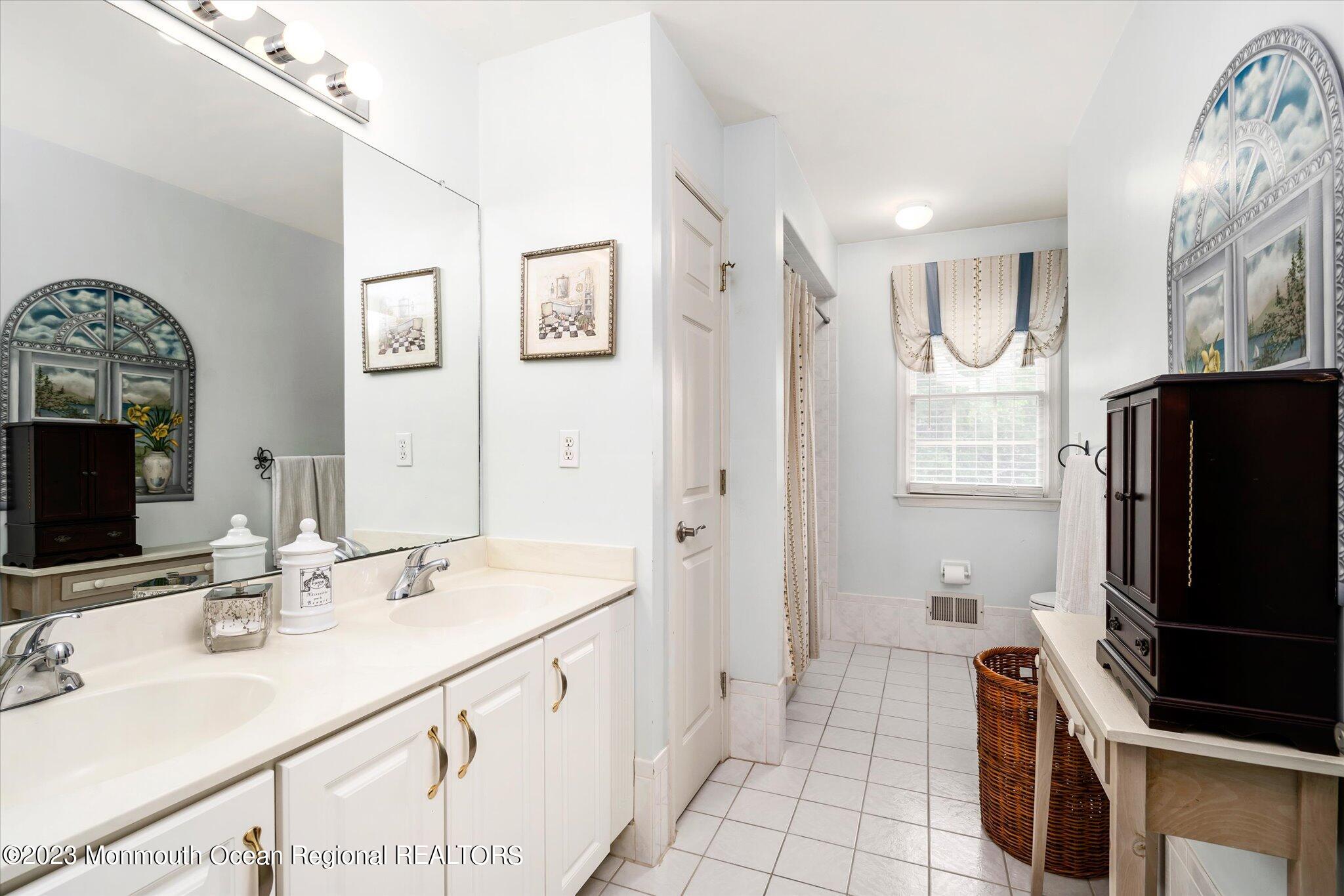 27 Millennium Drive Columbus, NJ 08022 - Photo 31 of 82 a bathroom with double vanity and a mirror