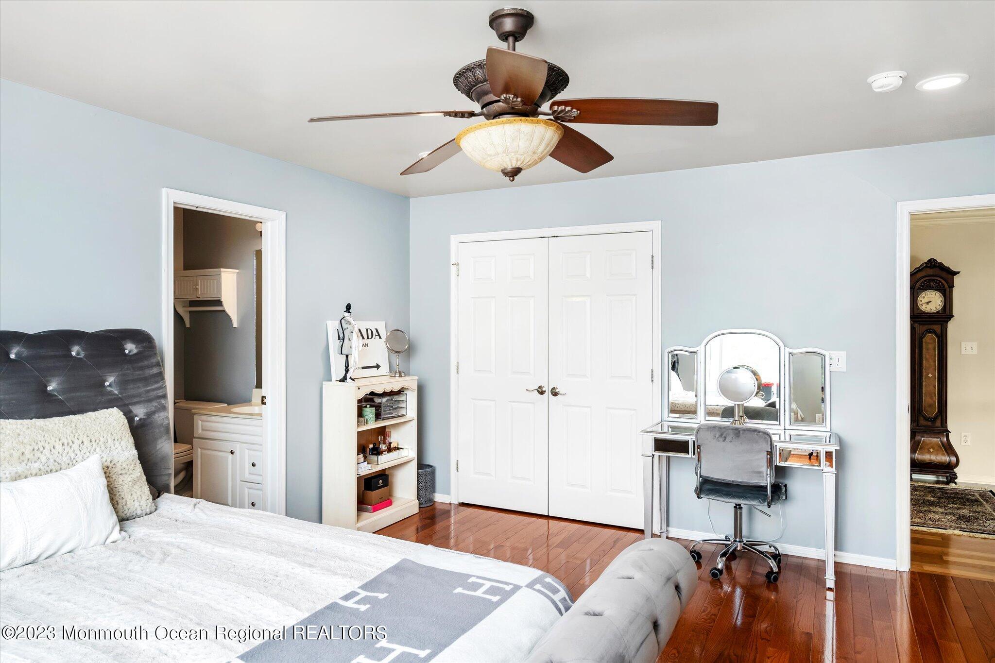 27 Millennium Drive Columbus, NJ 08022 - Photo 34 of 82 a bedroom with a bed and a chandelier