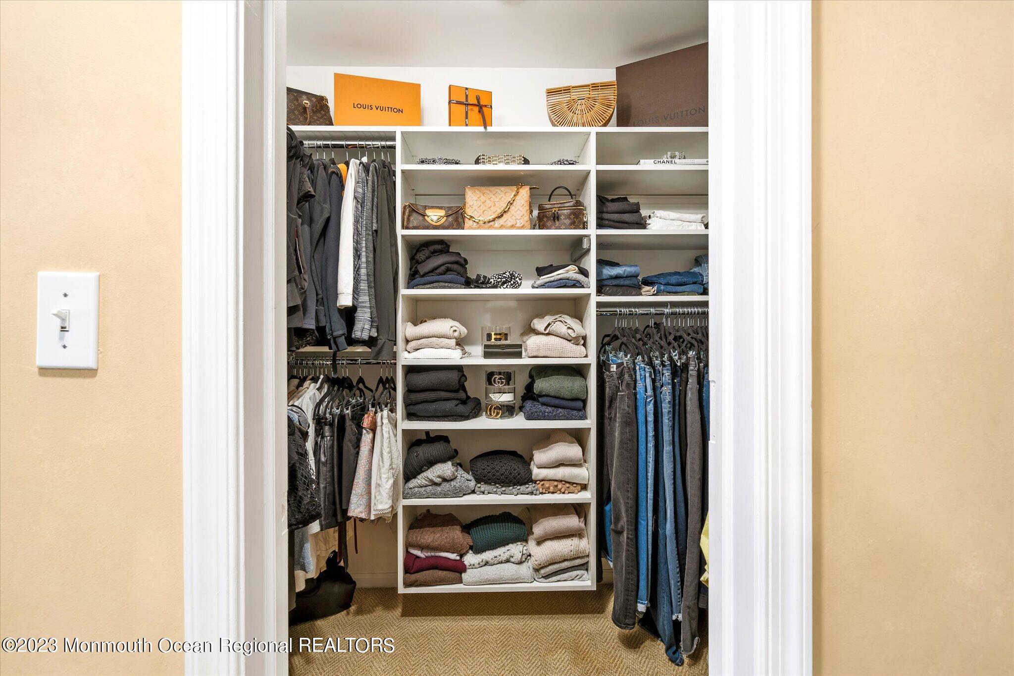 27 Millennium Drive Columbus, NJ 08022 - Photo 43 of 82 a view of a walk in closet with clothes and shoes