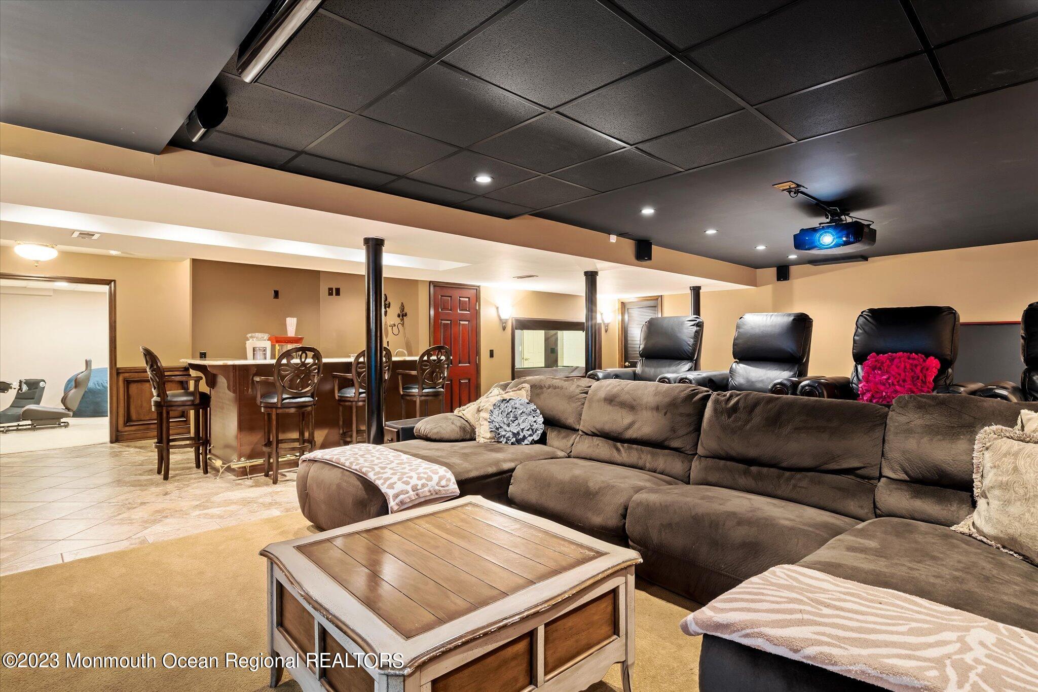 27 Millennium Drive Columbus, NJ 08022 - Photo 56 of 82 a living room with furniture and a glass table with projector