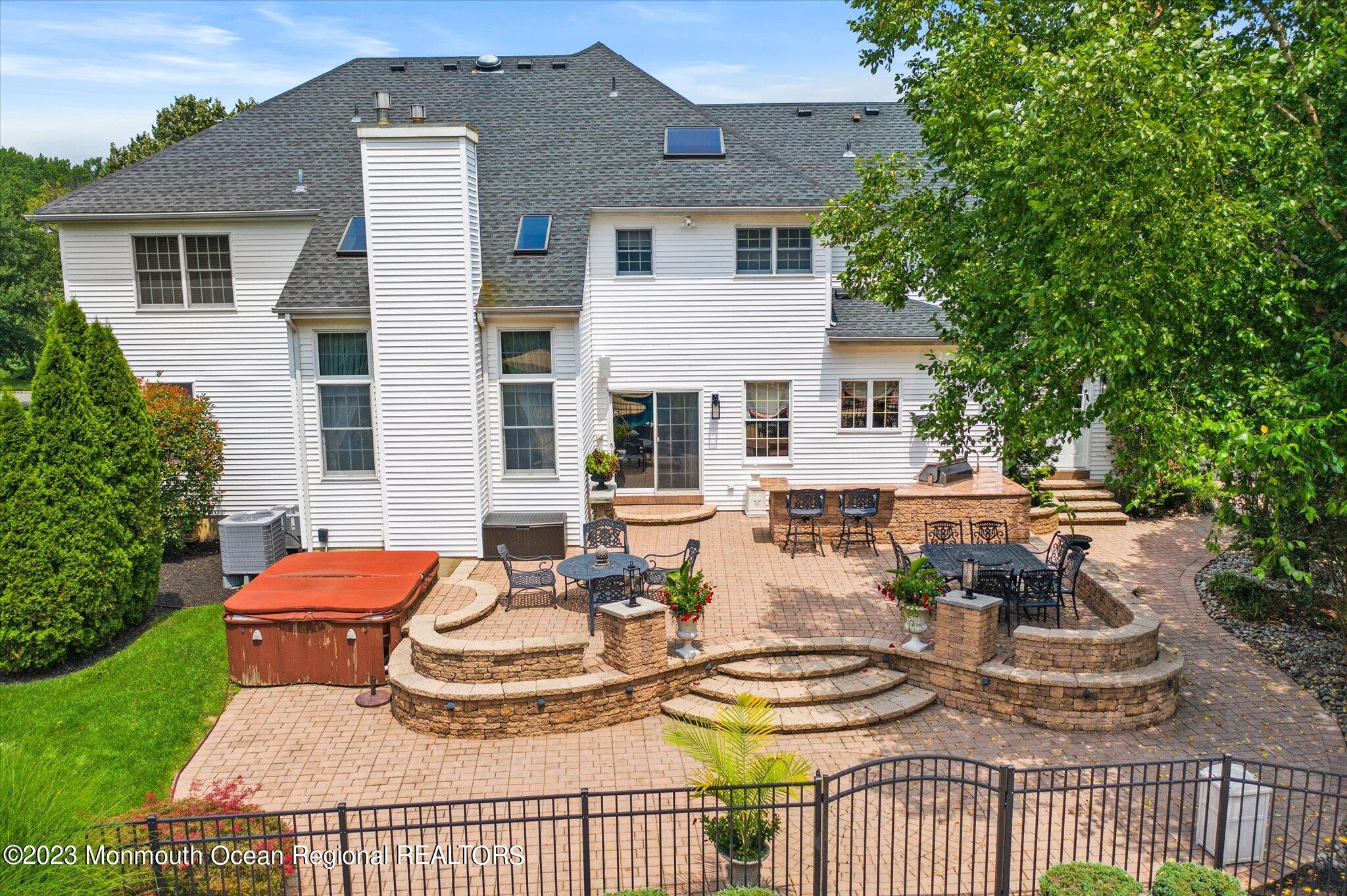 27 Millennium Drive Columbus, NJ 08022 - Photo 82 of 82 a view of a patio with couches table and chairs and potted plants