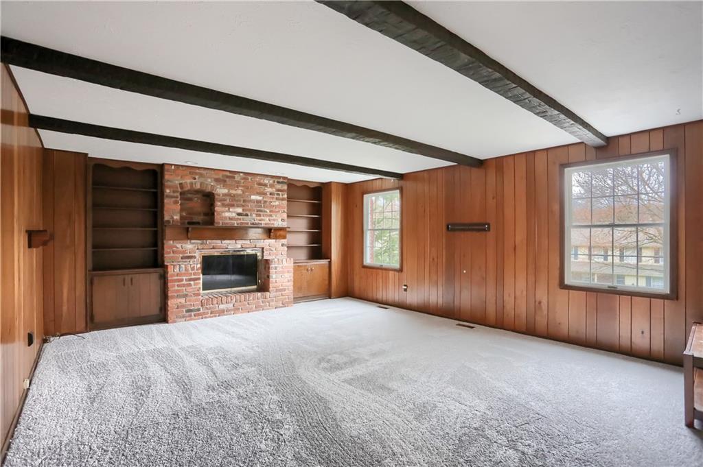 1889 Fairhill Road Allison Park, PA 15101 - Photo 12 of 25 The family room has a beautiful brick colonial fireplace with custom cabinets and shelving and a beamed ceiling.