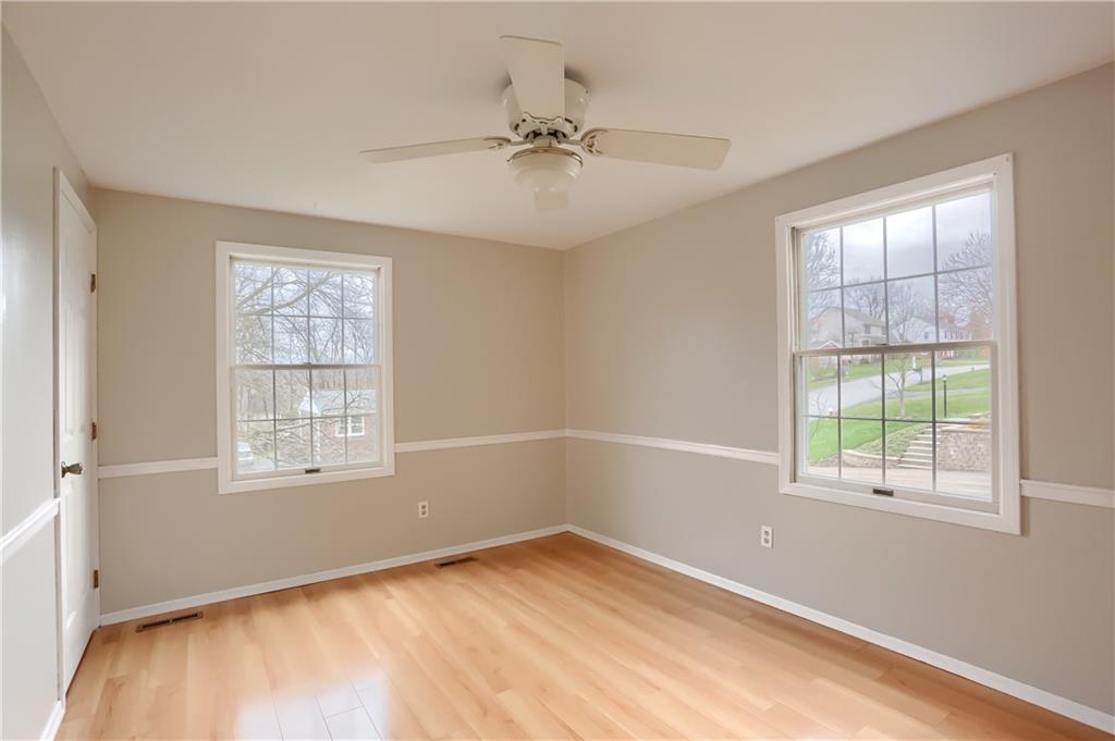 1889 Fairhill Road Allison Park, PA 15101 - Photo 20 of 25 The third bedroom has a closet, two windows, a lighted ceiling fan, chair rail and laminate flooring.