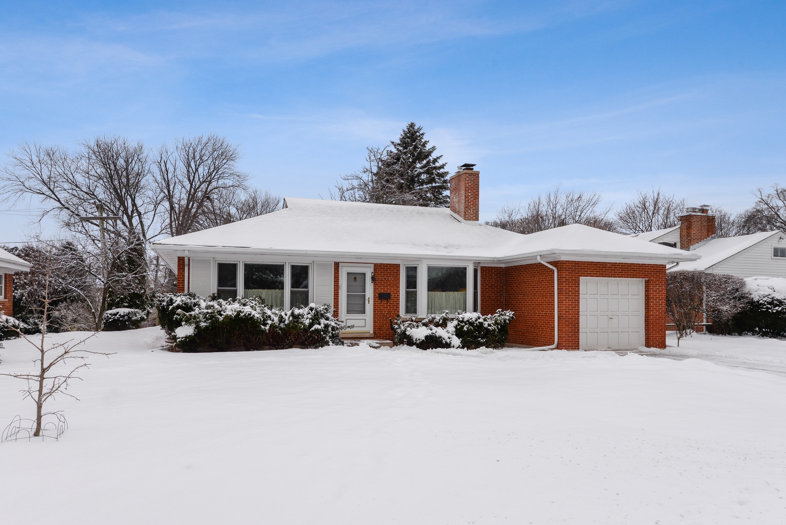 1135 Ridge Road Wilmette, IL 60091 - Photo 1 of 16 a view of a house with a yard covered in snow