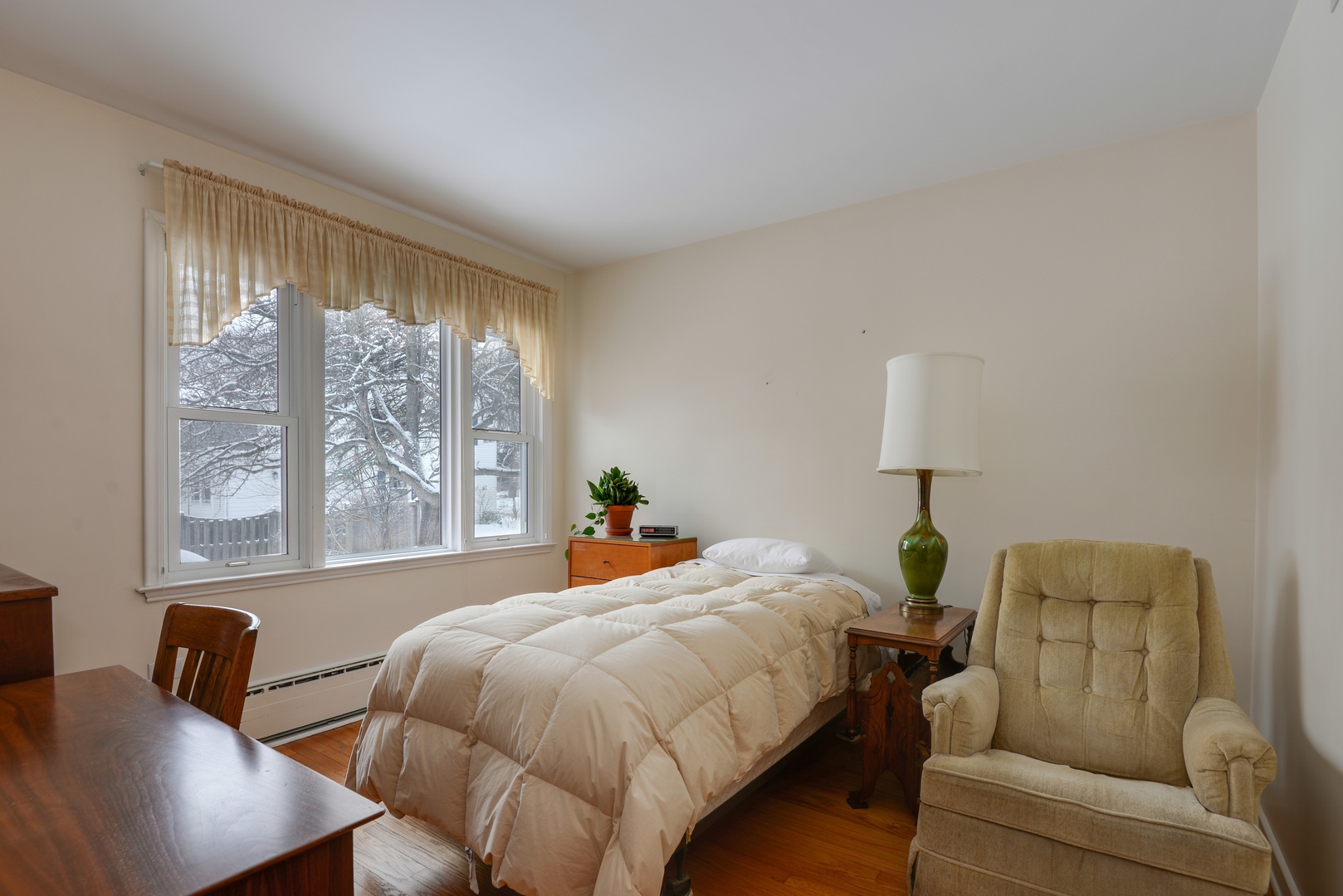 1135 Ridge Road Wilmette, IL 60091 - Photo 12 of 16 a bed room with a bed and a couch