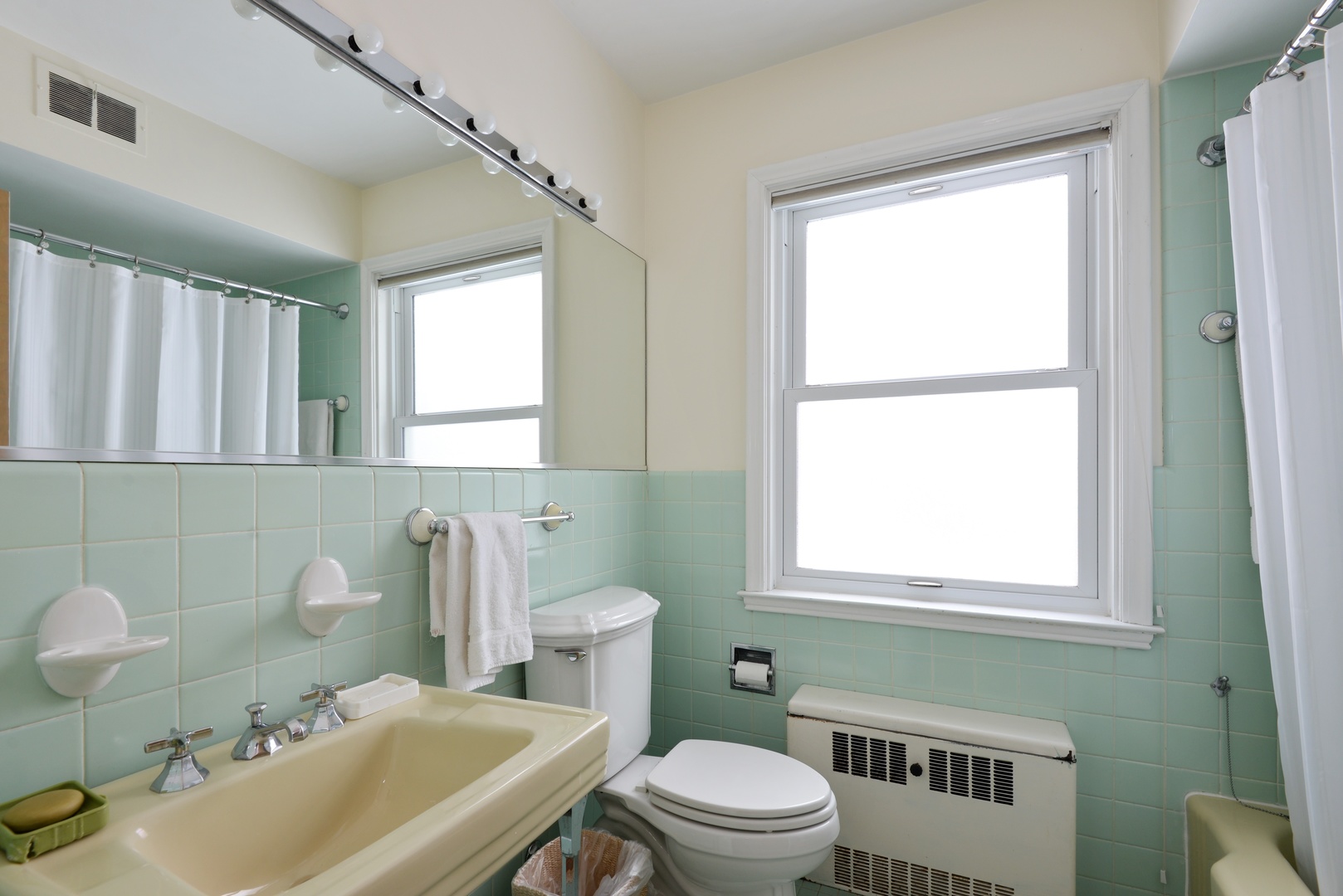 1135 Ridge Road Wilmette, IL 60091 - Photo 14 of 16 a bathroom with a sink toilet a mirror and window
