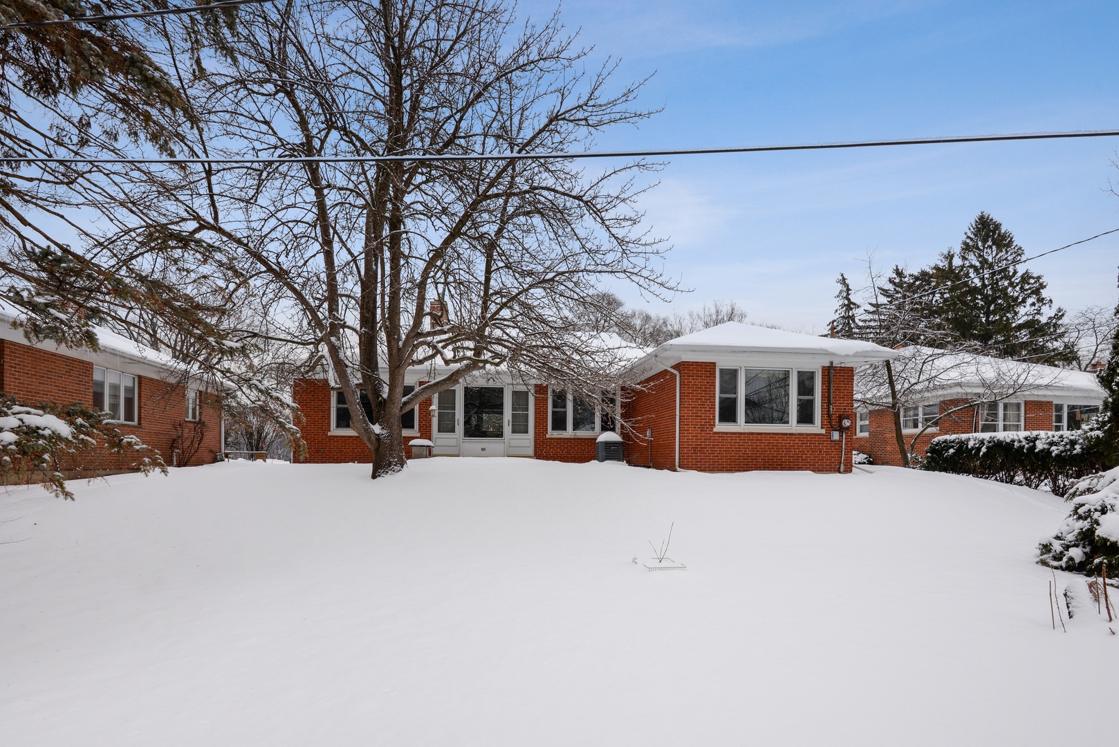 1135 Ridge Road Wilmette, IL 60091 - Photo 15 of 16 a front view of a building with a yard covered in snow