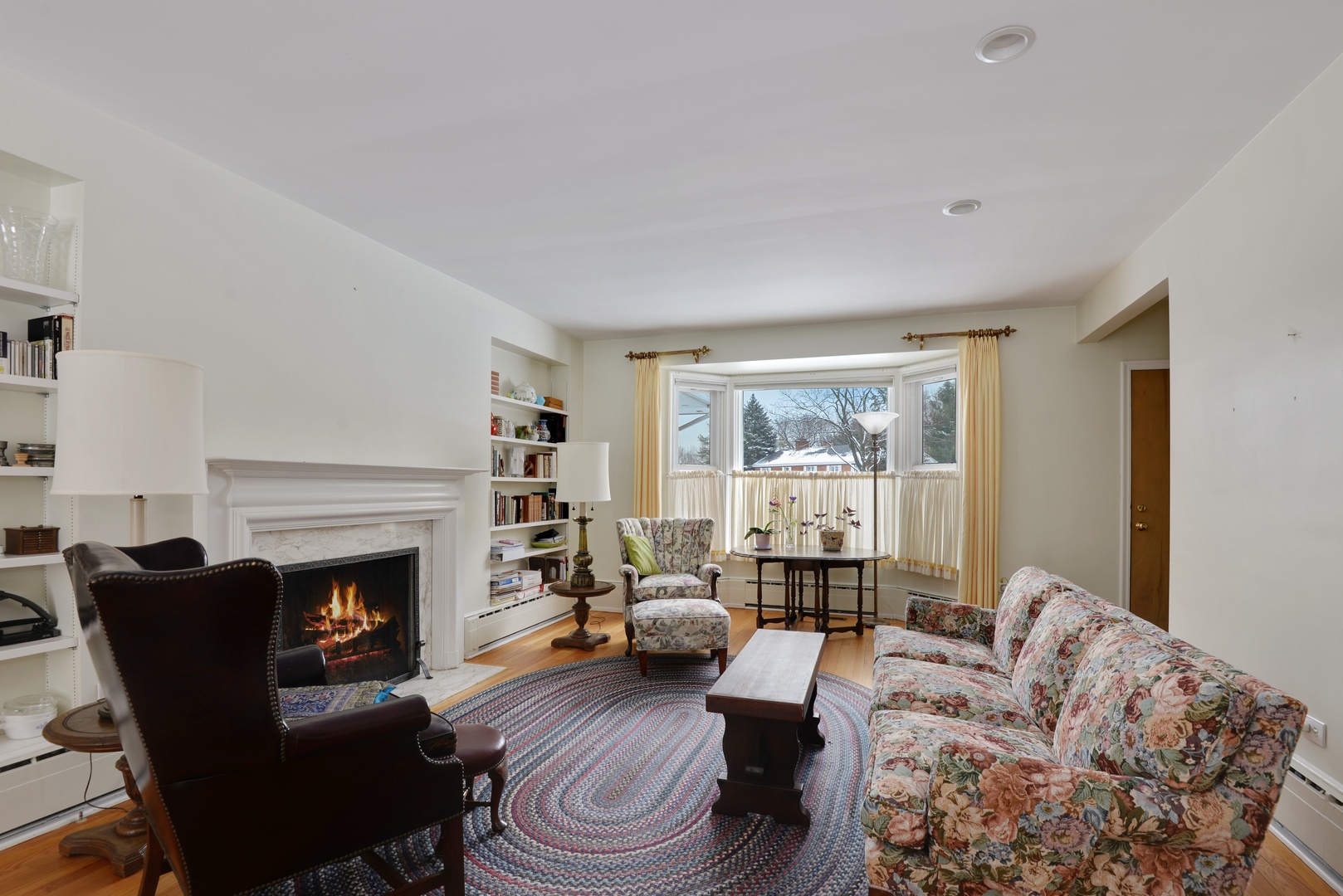 1135 Ridge Road Wilmette, IL 60091 - Photo 3 of 16 a living room with furniture large window and a fireplace