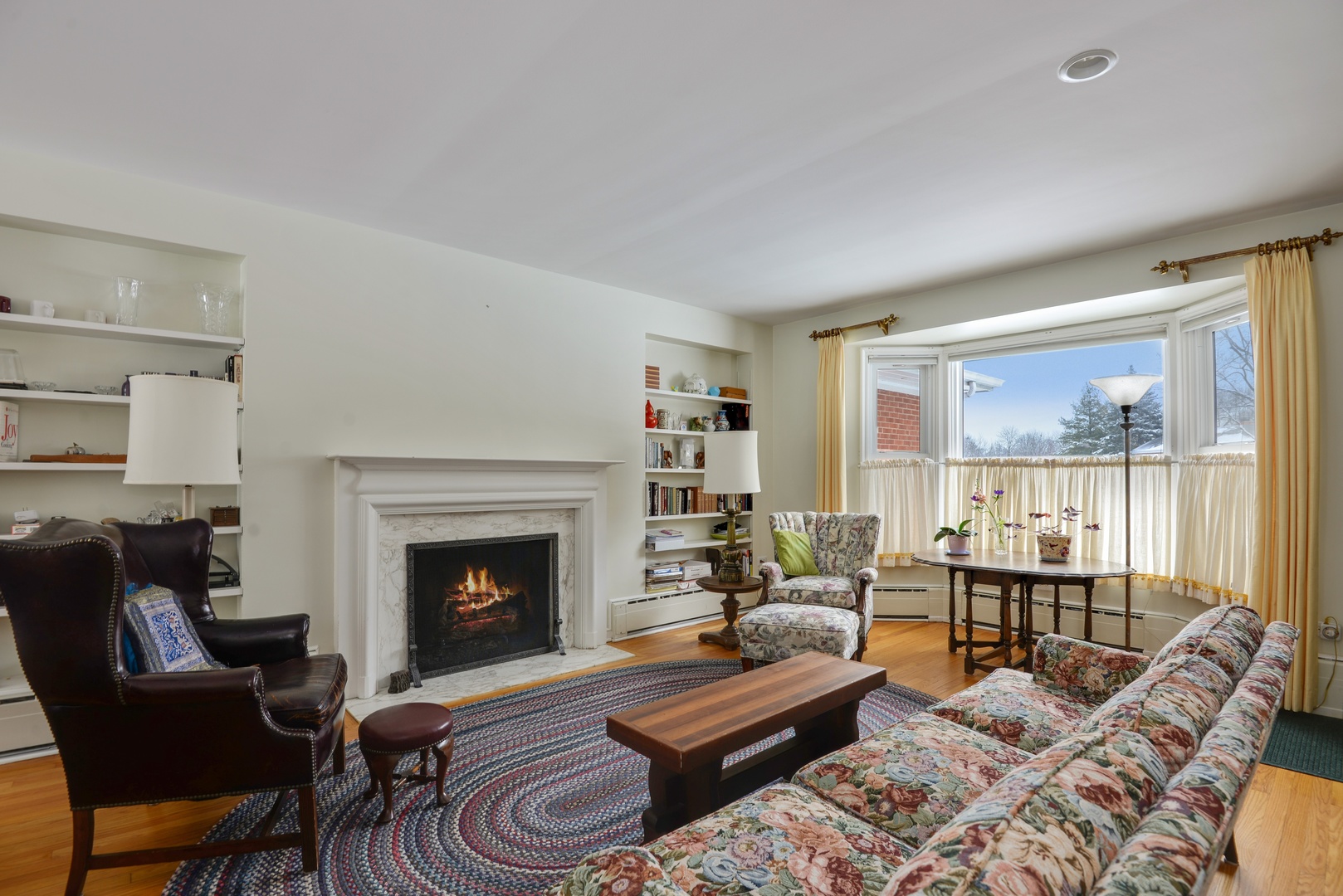 1135 Ridge Road Wilmette, IL 60091 - Photo 4 of 16 a living room with furniture large window and a fireplace
