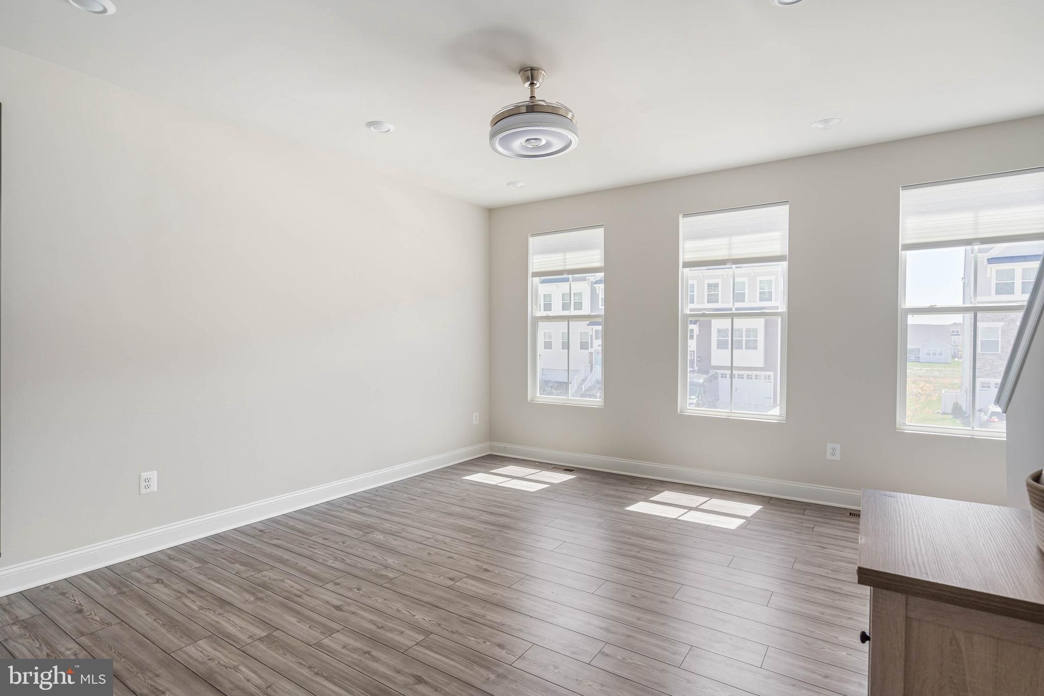 35303 Wright Way Millsboro, DE 19966 - Photo 14 of 26 an empty room with wooden floor and windows