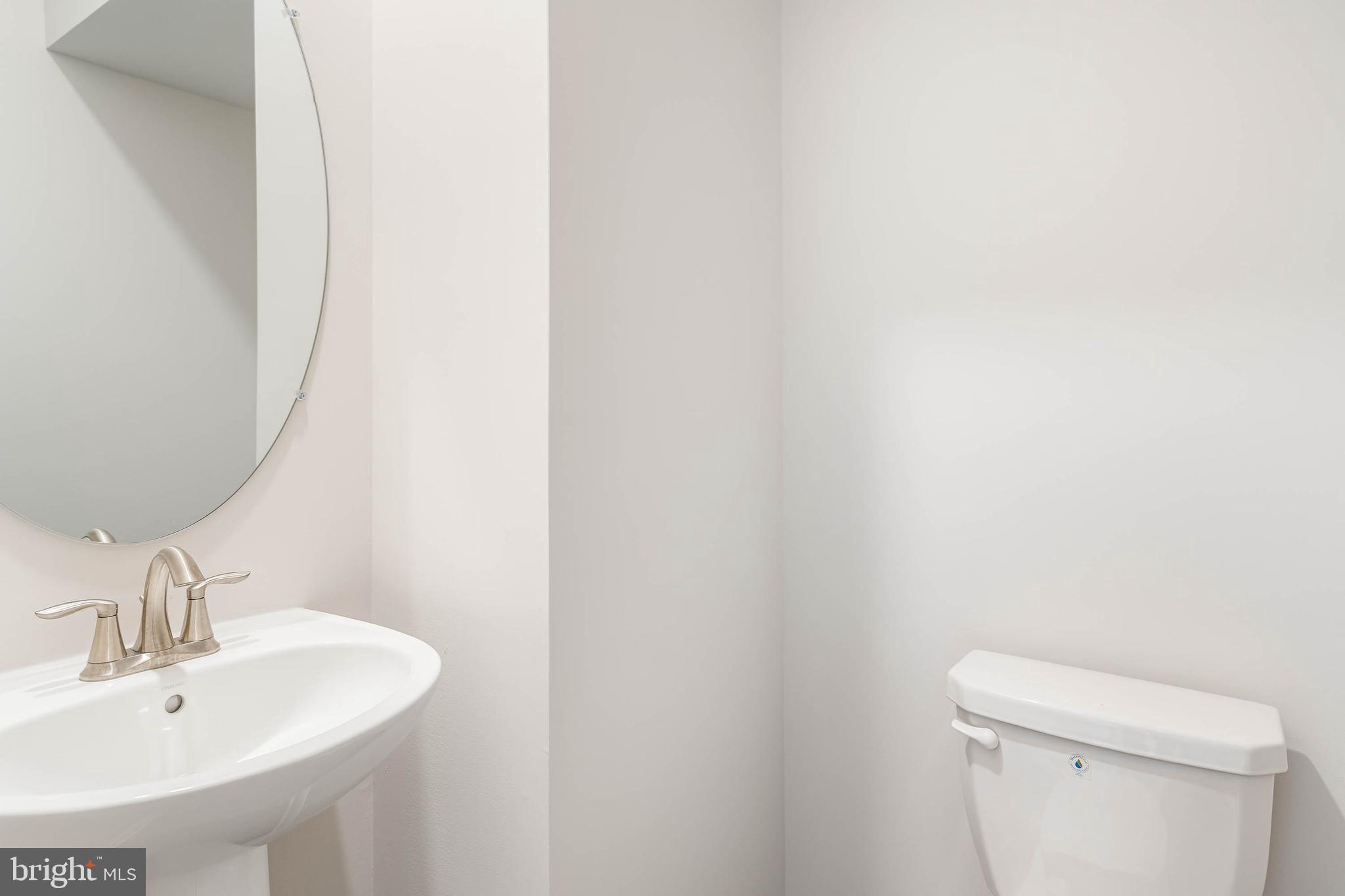 35303 Wright Way Millsboro, DE 19966 - Photo 18 of 26 a bathroom with a sink a toilet and mirror