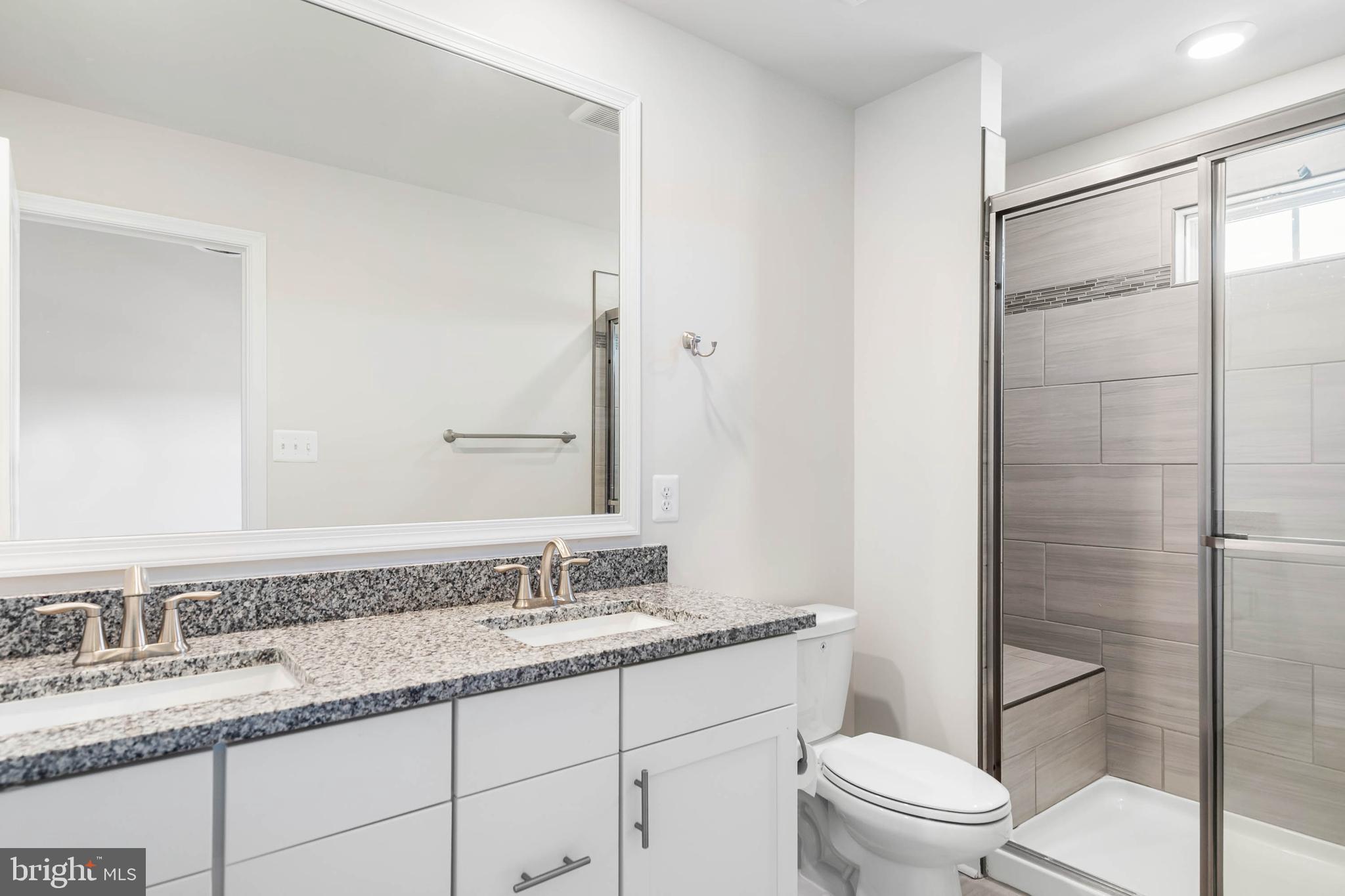 35303 Wright Way Millsboro, DE 19966 - Photo 21 of 26 a bathroom with a granite countertop sink toilet and shower