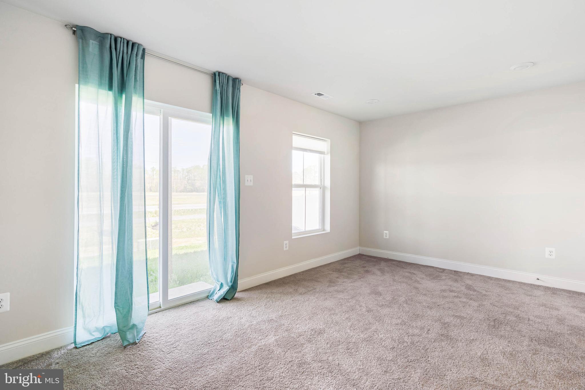 35303 Wright Way Millsboro, DE 19966 - Photo 4 of 26 an empty room with windows and closet