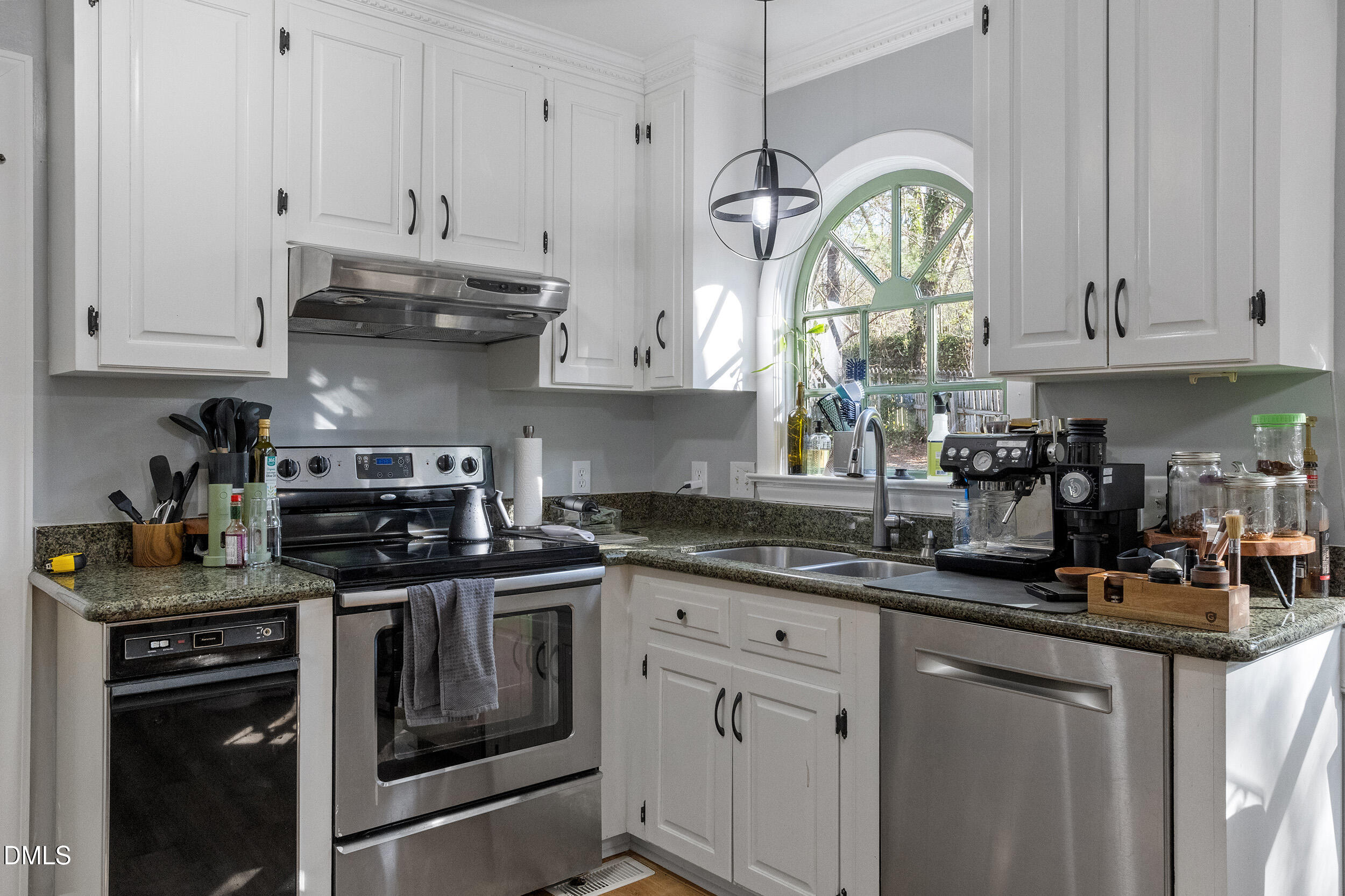 105 Barrett Place Durham, NC 27713 - Photo 18 of 25 a kitchen with stainless steel appliances granite countertop a sink a stove and cabinets