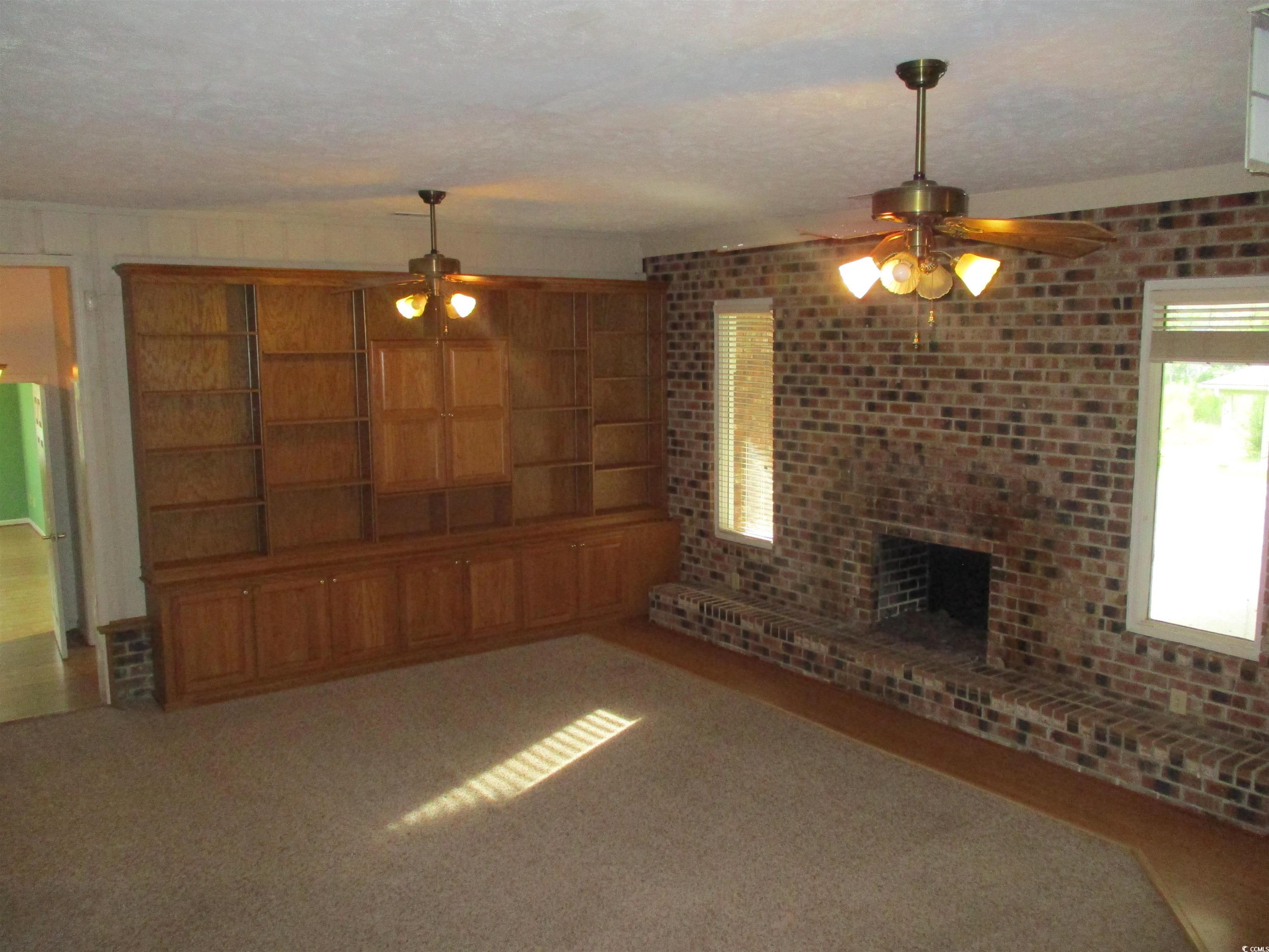 730 Highway 348 Loris, SC 29569 - Photo 12 of 36 Unfurnished living room featuring a textured ceili