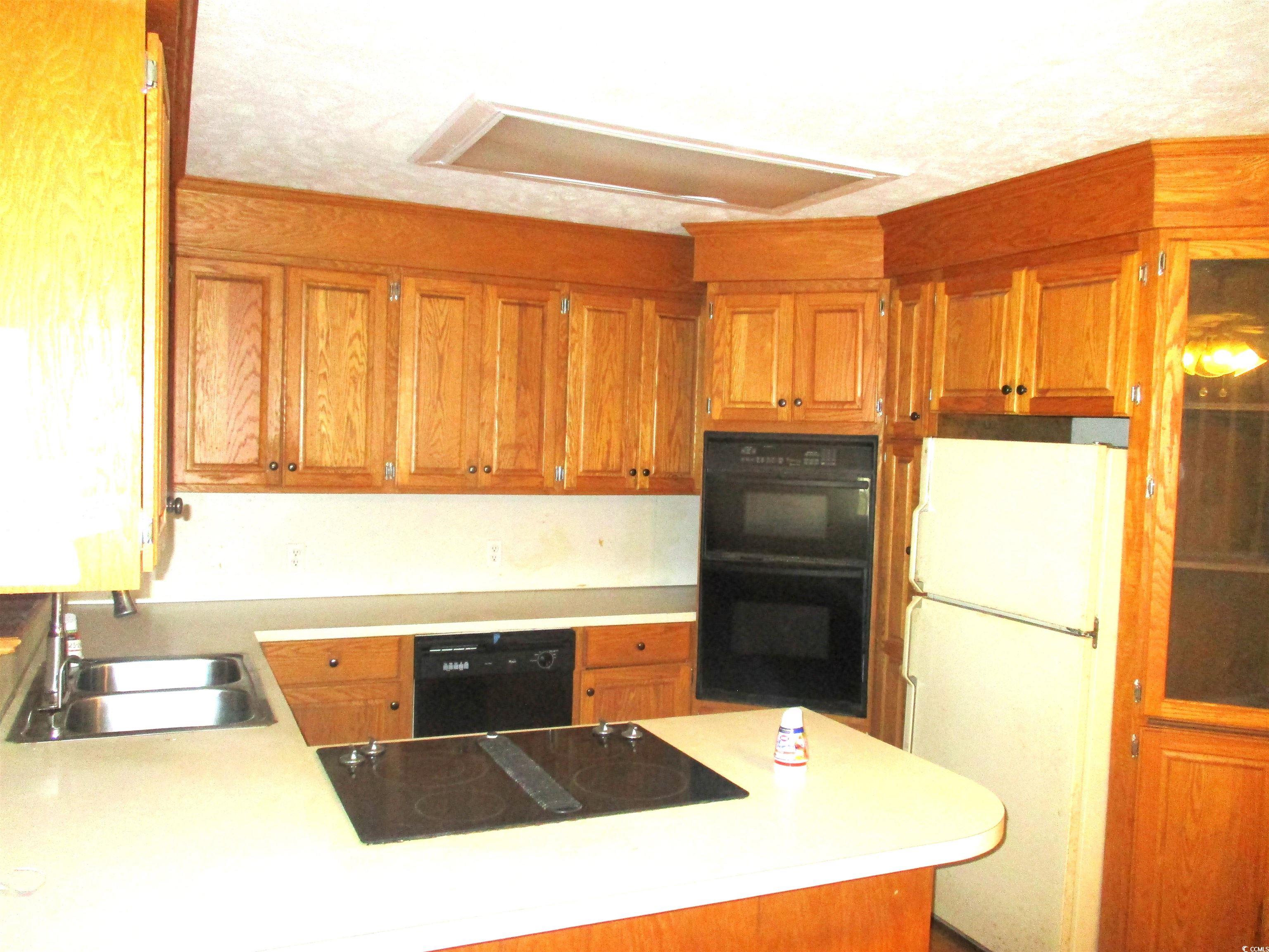 730 Highway 348 Loris, SC 29569 - Photo 15 of 36 Kitchen with black appliances, kitchen peninsula,